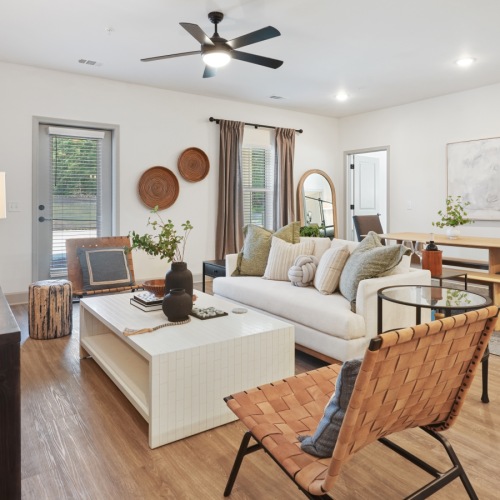 living room area with chair and sofa  in a room with a window living room area with chair and sofa  in a room with a window